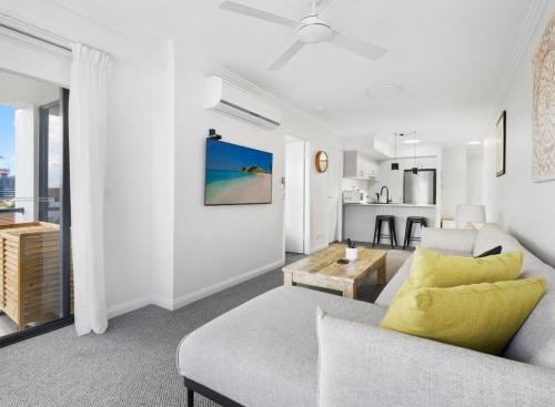 a living room with a couch and a table at Broadwater Parklands Paradise in Gold Coast