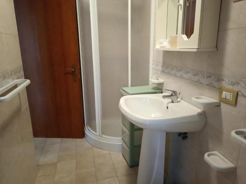 a bathroom with a white sink and a shower at Residence La Playa in Marina di Camerota