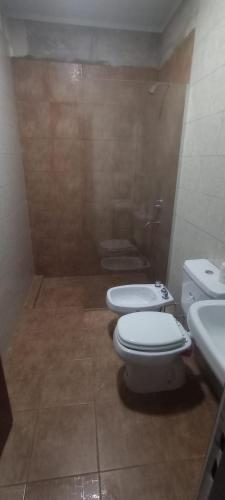 a bathroom with two toilets and a sink at Casa Chuchi in Reconquista