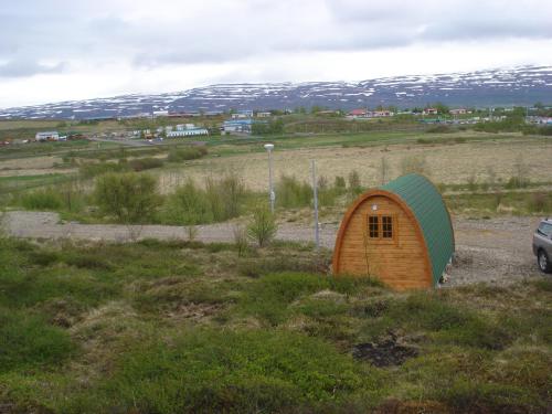 a small tent in the middle of a field at Vinland Camping Pods in Egilsstadir