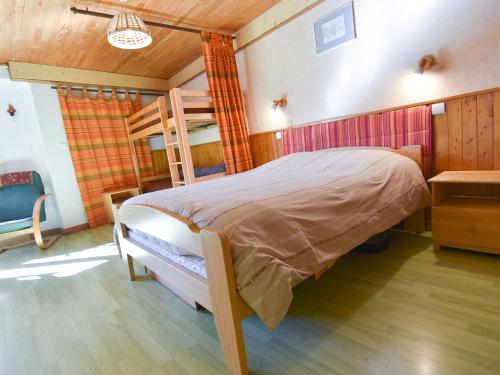 a bedroom with a large bed in a room with a table at Appartement Valloire, 2 pièces, 5 personnes - FR-1-263-161 in Valloire