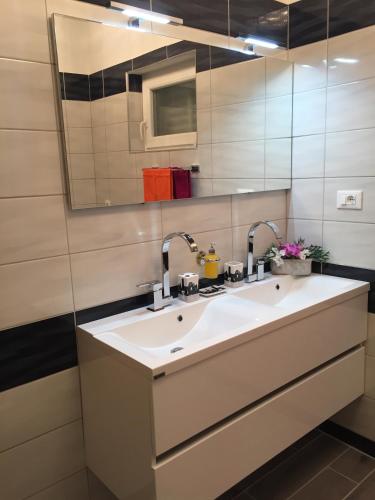 a bathroom with a sink and a mirror at Apartments Stakic in Krvavica