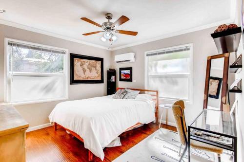 a bedroom with a bed and a ceiling fan at Smart Eclectic ART HOUSE near the beat in Sacramento