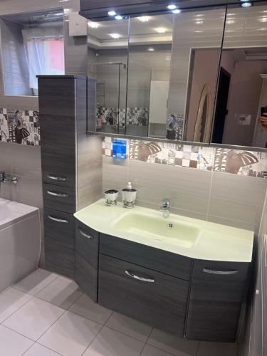 a bathroom with a sink and a mirror at Star Street Home in Mosonmagyaróvár