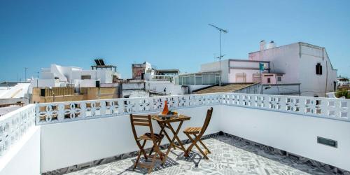 a table and chairs on the roof of a building at KASA BLANCA in Olhão
