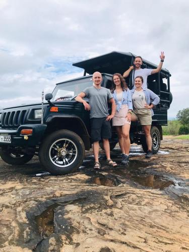a group of people standing in front of a jeep at Nature World Udawalawe in Udawalawe