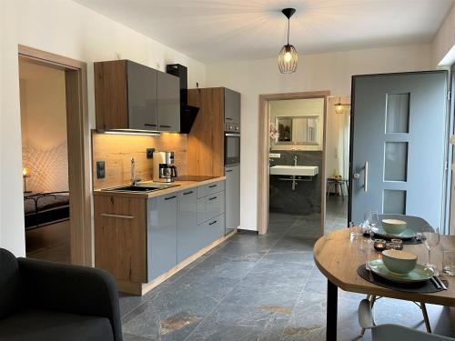 a kitchen with a table and a dining room at Apartment Joel by Interhome in Stockach