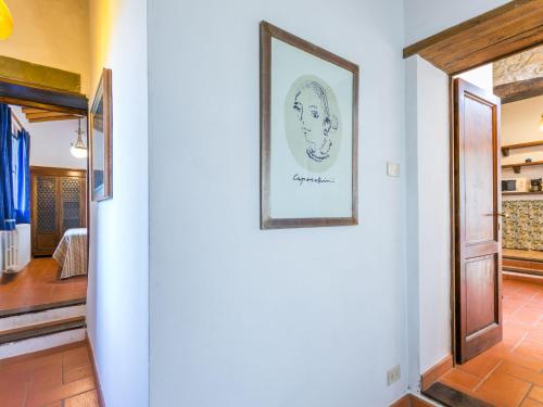 a picture of a woman on a wall in a hallway at Holiday Home Ridaldi by Interhome in Greve in Chianti