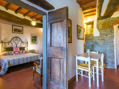 a bedroom with a bed and a table in a room at Holiday Home Ridaldi by Interhome in Greve in Chianti