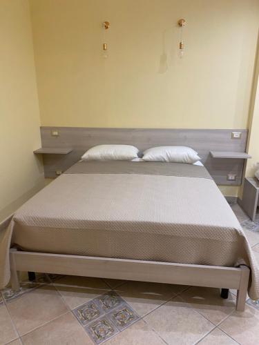 a bed with two pillows on it in a room at Villa Vittoria in Matera
