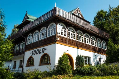 a large white building with a roof at Willa JODŁA Wisła in Wisła