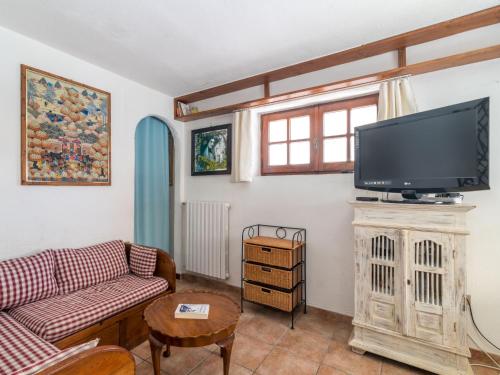 a living room with a couch and a flat screen tv at Apartment Rosemary by Interhome in Palau