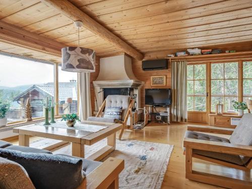 a living room with a couch and a table at Chalet Korpstigen Älgen - DAN075 by Interhome in Sälen