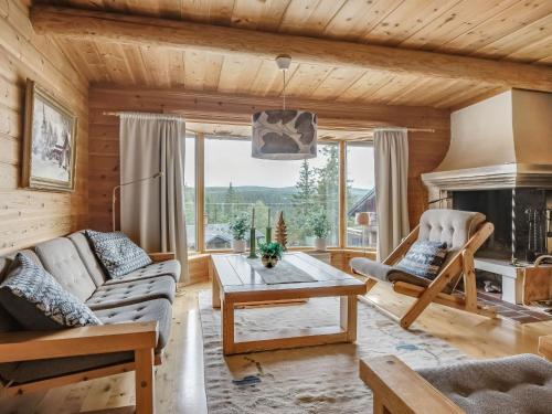 a living room with a couch and a fireplace at Chalet Korpstigen Älgen by Interhome in Sälen