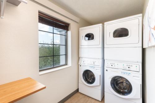 a laundry room with two washer and dryer at Candlewood Suites Eagan - Mall of America Area by IHG in Eagan