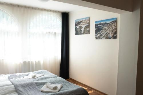a bedroom with a bed with towels on it at Willa JODŁA Wisła in Wisła