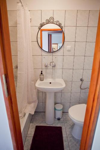 a bathroom with a sink and a mirror and a toilet at Willa JODŁA Wisła in Wisła