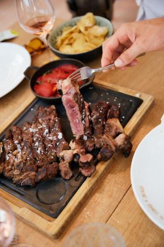 a plate of food with meat on a table at Zel Mallorca in Palmanova