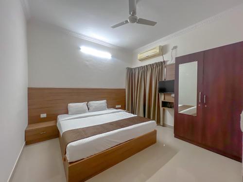 a bedroom with a bed and a tv in it at Hotel Elite By Agira Hotels-Free Airport Pickup or Drop in Yelahanka