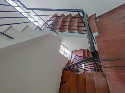 a spiral staircase in a building with wooden floors at Hotel Elite By Agira Hotels-Free Airport Pickup or Drop in Yelahanka