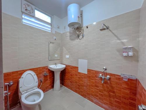 a bathroom with a toilet and a sink at Hotel Elite By Agira Hotels-Free Airport Pickup or Drop in Yelahanka