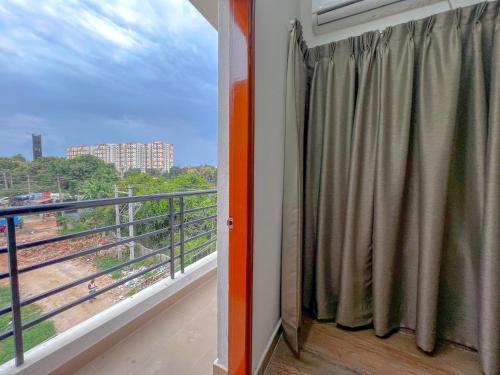 a balcony with a window with a view of a train at Hotel Elite By Agira Hotels-Free Airport Pickup or Drop in Yelahanka