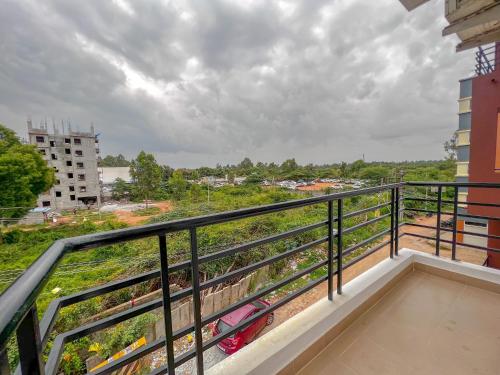a balcony with a view of a car at Hotel Elite By Agira Hotels-Free Airport Pickup or Drop in Yelahanka