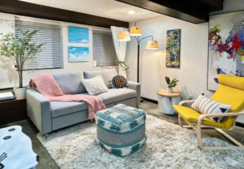 a living room with a couch and a chair at Artist's apartment in the heart of the city in Sacramento