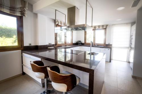 a kitchen with a large island with a counter top at Private Villa Martaver, swiming pool, BBQ & Pool table in Muchamiel
