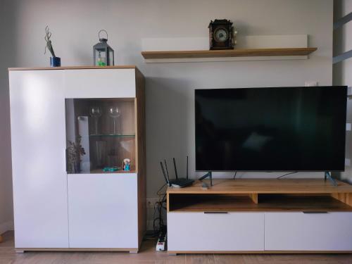 a large white entertainment center with a flat screen tv at Apartament z pięknym widokiem in Nowy Dwór Mazowiecki