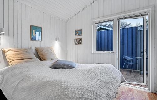 a white bedroom with a bed and a window at Stunning Home In Ebeltoft With 2 Bedrooms And Wifi in Ebeltoft