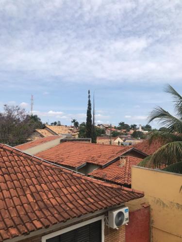 a view of roofs of houses with a palm tree at HOUSE DORA AP 03 com AR CONDICIONADO in Campo Grande