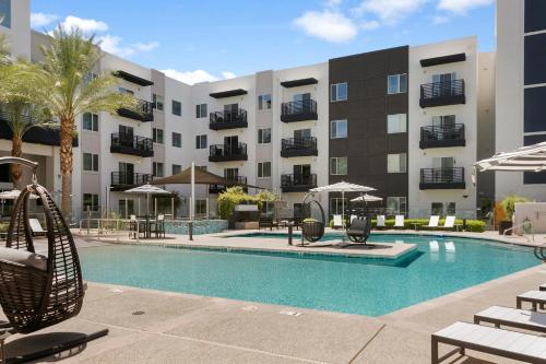 a swimming pool in front of a apartment building at Premium One and Two Bedroom Apartments at Slate Scottsdale in Phoenix Arizona in Scottsdale