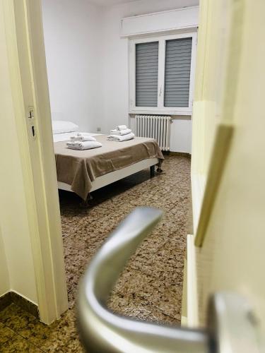 a hospital room with a bed and a window at SHUBY HOME in San Pietro Vernotico