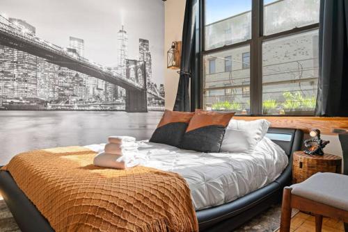 a bed in a room with a large window at Artistic Loft A Century-Old Gem in Brooklyn
