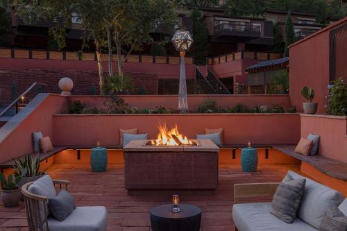 a patio with a fire pit in a courtyard at L'Auberge De Sedona in Sedona