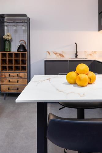 a pile of lemons on a table in a kitchen at Calatrava by Alma Suites in Valencia