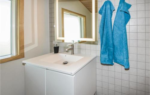 a bathroom with a white sink and a mirror at Stunning Home In Ebeltoft With 4 Bedrooms And Wifi in Ebeltoft