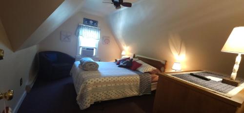a small bedroom with a bed and a window at Old Orchard Beach Inn in Old Orchard Beach