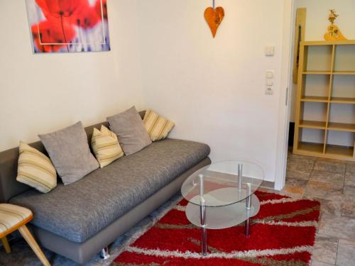 a living room with a couch and a glass table at Apartment Schöngraben by Interhome in Sankt Jakob