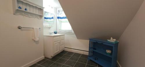 a bathroom with a blue cabinet and a window at Old Orchard Beach Inn in Old Orchard Beach