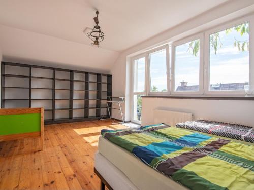 a bedroom with a bed and a large window at Holiday Home Parkowa by Interhome in Koszalin
