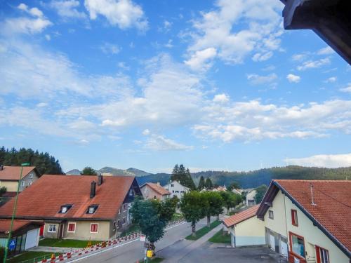 a view of a village with houses and a blue sky at Apartment Grand-Rue 143 by Interhome in Auberson