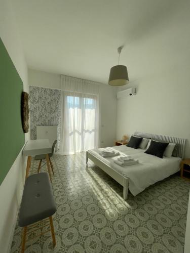 a bedroom with a bed and a chair in it at Green House Calolziocorte in Calolziocorte
