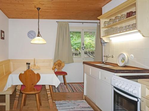 a kitchen with a table and chairs and a sink at Chalet Lieblingsplatz by Interhome in Flirsch