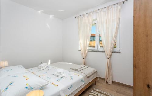 A bed or beds in a room at Gorgeous Apartment In Mladenici With Kitchen