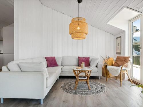 een woonkamer met een witte bank en een tafel bij Holiday Home Blaguna - 600m from the sea in NW Jutland by Interhome in Torsted
