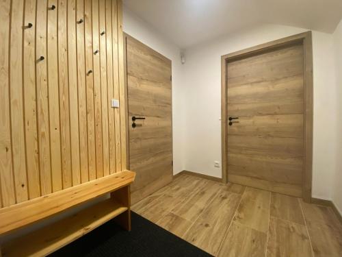 a room with wooden walls and a wooden door at Holiday Home Muhu by Interhome in Smržovka