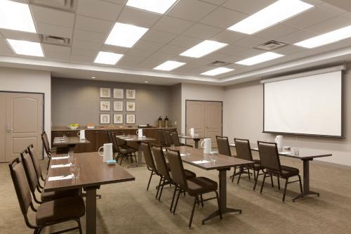 a conference room with tables and chairs and a whiteboard at Country Inn & Suites by Radisson, Bloomington at Mall of America, MN in Bloomington