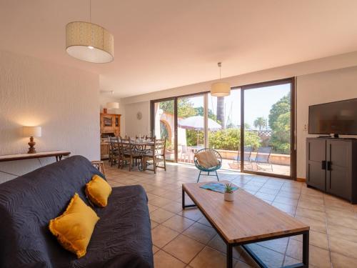 a living room with a couch and a table at Villa Cantegril by Interhome in Hyères